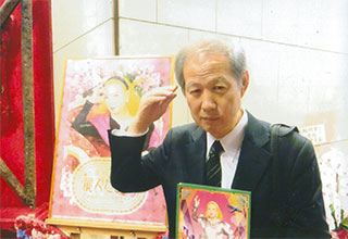 美輪さんのポスターの前で。美輪さんの真似をして